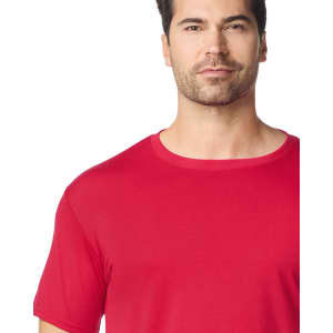 A red Gildan Performance adult t-shirt featuring a round neckline and short sleeves, with a logo on the fabric.