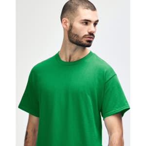 A green Gildan Heavy Cotton Adult T-Shirt displayed on a model, featuring a simple design and a logo.
