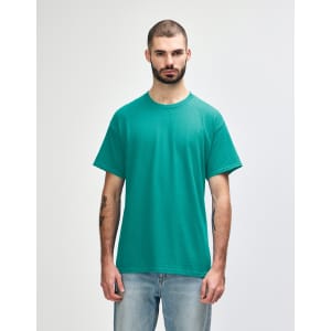 A turquoise Gildan Heavy Cotton adult T-shirt displayed on a model, featuring a round neck and short sleeves.