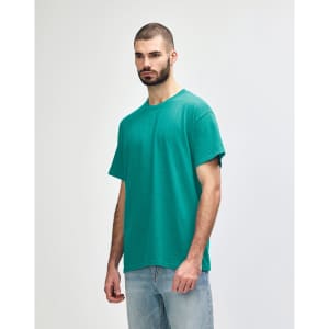 A turquoise Gildan Heavy Cotton Adult T-Shirt displayed on a male model, featuring a simple design and a logo.