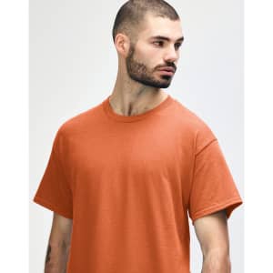 A red Gildan Heavy Cotton adult T-shirt displayed on a model with a casual pose and a blank background.