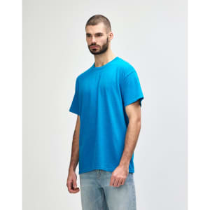 A blue Gildan Heavy Cotton adult t-shirt displayed on a model, featuring a simple design and a logo.