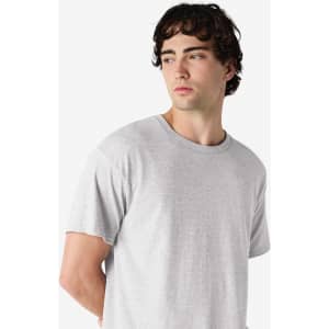 A grey Gildan Heavy Cotton Adult T-Shirt displayed on a model, featuring a round neckline and short sleeves.
