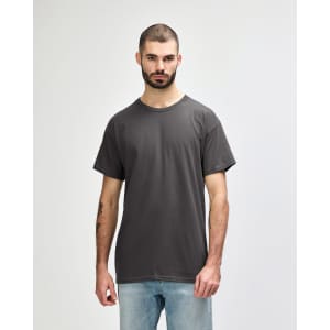 A grey Gildan Heavy Cotton Adult T-Shirt worn by a model, featuring a classic crew neck design and short sleeves.