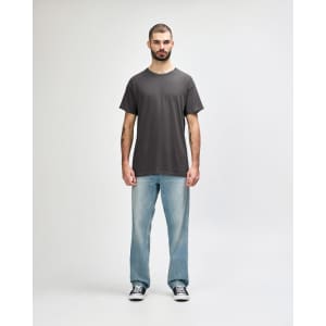 A grey Gildan Heavy Cotton Adult T-Shirt displayed on a male model, paired with black jeans and sneakers.