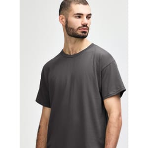 A grey Gildan Heavy Cotton adult T-shirt displayed on a male model with a neutral background.