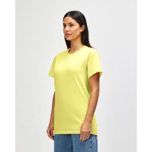 A yellow Gildan Heavy Cotton Adult T-Shirt displayed on a model, featuring a simple design and a relaxed fit.