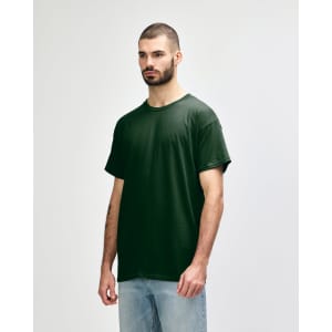A green Gildan Heavy Cotton Adult T-Shirt displayed on a model, featuring a logo on the front.