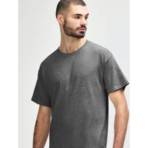 A grey Gildan Heavy Cotton Adult T-Shirt displayed on a model, featuring a simple design and a logo.