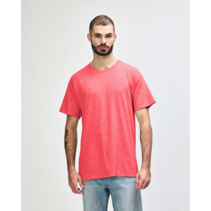 A model wearing a vibrant coral Gildan Heavy Cotton Adult T-Shirt with a relaxed fit.