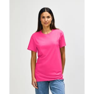A pink Gildan Heavy Cotton adult T-shirt displayed on a model with a neutral background. The shirt features a logo.