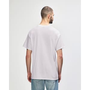 A man wearing a light grey Gildan Heavy Cotton Adult T-Shirt, viewed from the back. The shirt has a logo.