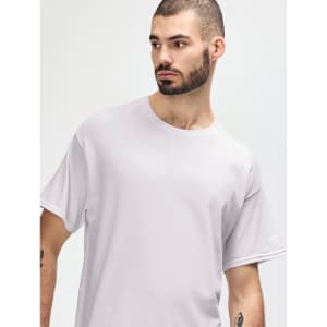 A man models a white Gildan Heavy Cotton Adult T-Shirt, featuring a round neckline and a simple design.