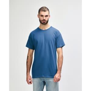 A blue Gildan Heavy Cotton Adult T-Shirt on a model, featuring a plain design and a logo on the label.