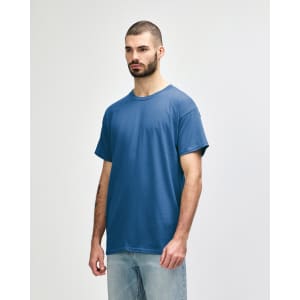 A blue Gildan Heavy Cotton adult t-shirt displayed on a model, featuring a simple design and a logo.