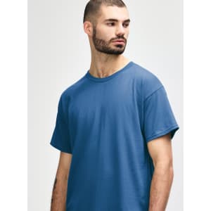A blue Gildan Heavy Cotton adult t-shirt displayed on a model, featuring a simple design and a logo.