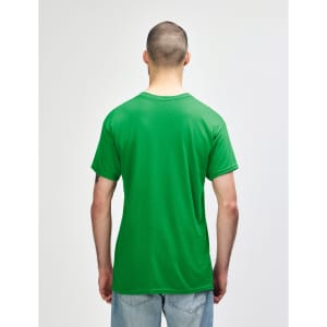 A man wearing a green Gildan Heavy Cotton adult T-shirt, viewed from the back. The shirt has a logo on it.