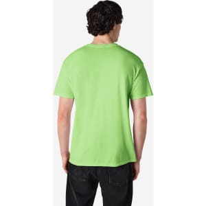 A man wearing a bright green Gildan Heavy Cotton Adult T-Shirt, viewed from the back. The shirt has a logo on it.