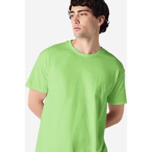 A model wearing a bright green Gildan Heavy Cotton adult T-shirt, featuring a simple design and a logo.