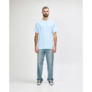 A light blue Gildan Heavy Cotton adult t-shirt displayed on a male model wearing black pants and sneakers.
