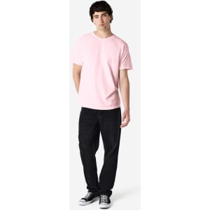 A pink Gildan Heavy Cotton adult T-shirt displayed on a male model, paired with black pants and sneakers.