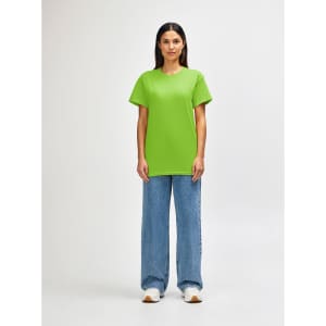 A green Gildan Heavy Cotton adult T-shirt is displayed on a model, paired with light blue jeans.