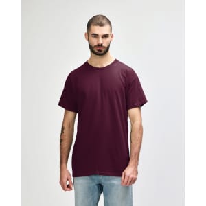 A maroon Gildan Heavy Cotton Adult T-Shirt on a model, featuring short sleeves and a round neck, with a logo.