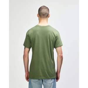 A man wearing a plain olive green Gildan Heavy Cotton Adult T-Shirt, viewed from the back. The shirt has a logo.