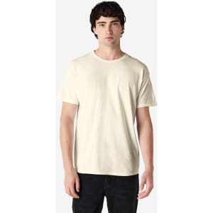 A light beige adult t-shirt with a round neck and short sleeves, featuring a logo.