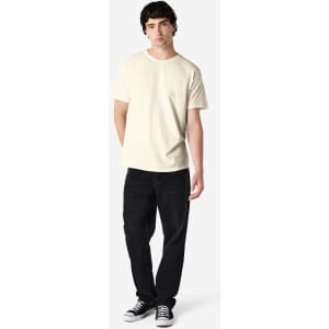 A light cream Gildan Heavy Cotton adult T-shirt displayed on a male model, paired with black jeans and casual shoes.