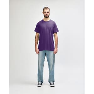 A purple Gildan Heavy Cotton Adult T-Shirt displayed on a model, paired with black jeans and casual shoes.