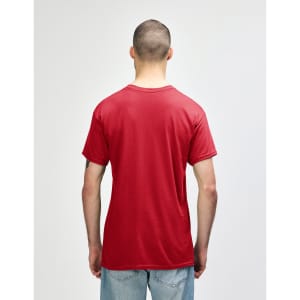 A red Gildan Heavy Cotton adult T-shirt displayed from the back on a model wearing black pants.