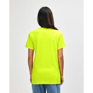 A man wearing a bright yellow Gildan Heavy Cotton adult T-shirt viewed from the back. The shirt has a logo.