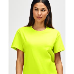 A bright yellow Gildan Heavy Cotton Adult T-Shirt is displayed on a model with short dark hair.