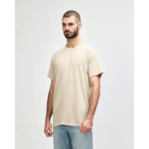 A light beige adult t-shirt in a casual style, featuring a crew neck and short sleeves. It has a branding logo on the tag.