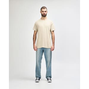 A light beige Gildan Heavy Cotton Adult T-Shirt worn by a male model, paired with black jeans and sneakers.