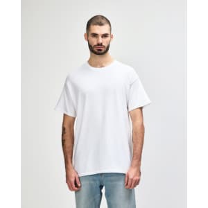A plain white Gildan Heavy Cotton adult T-shirt on a model, featuring short sleeves and a round neckline.