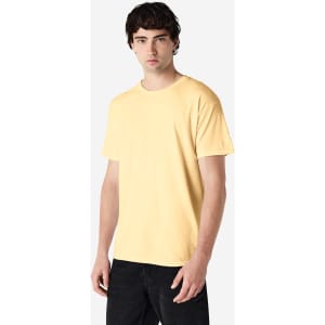A yellow Gildan Heavy Cotton Adult T-Shirt displayed on a model, featuring a simple design and a logo.