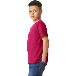 A youth t-shirt in a vibrant magenta colour, featuring a logo, worn by a young person.