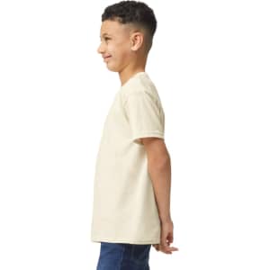 A light beige youth t-shirt displayed on a model in profile view, featuring a logo on one side.