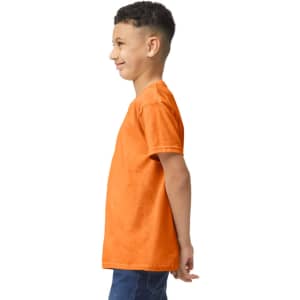 An orange Gildan Heavy Cotton Youth T-Shirt is displayed on a child from the side, showcasing its fit and style.