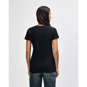 A black Gildan Heavy Cotton Ladies' T-Shirt is displayed from the back, worn with blue jeans. The shirt has a logo.
