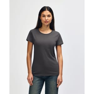 A woman models a dark grey Gildan Heavy Cotton ladies' T-shirt, featuring a classic crew neck and short sleeves.