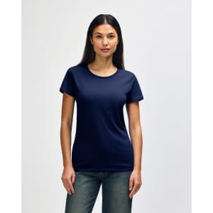 A navy blue Gildan Heavy Cotton ladies' T-shirt displayed on a model, featuring a logo on the sleeve.