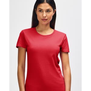 A red Gildan Heavy Cotton ladies' t-shirt is displayed, worn by a smiling woman. It features a logo on the shirt.