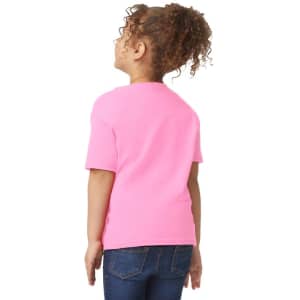 A toddler wearing a bright pink Gildan Heavy Cotton T-Shirt, viewed from the back, with curly hair and blue jeans.
