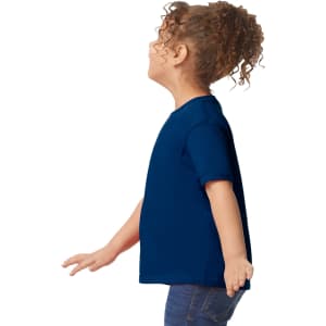 A toddler wearing a side-view navy blue Gildan Heavy Cotton T-Shirt with a plain design.
