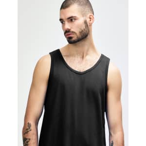 A black Gildan Heavy Cotton adult tank top displayed on a model. The tank features a round neckline and a relaxed fit.