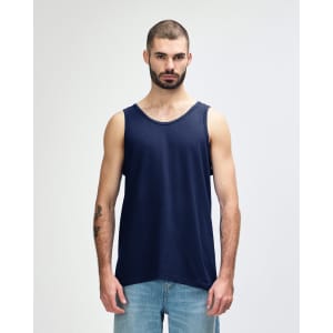 A navy Gildan Heavy Cotton adult tank top on a model standing against a plain background. The tank top has a logo.