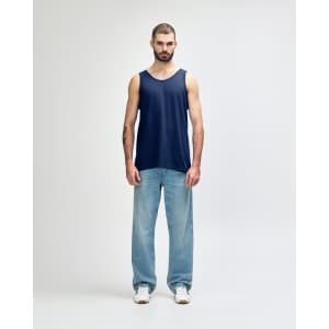A navy blue adult tank top displayed on a male model, paired with black pants and sneakers. The top features a logo.